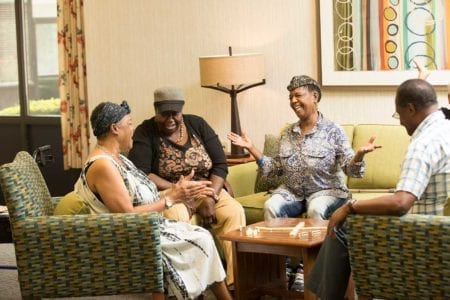 About Branan Towers - old seniors talking around the sitting area