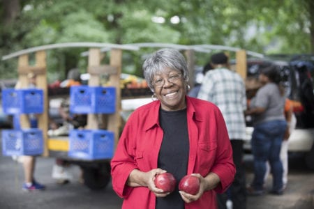 Senior Lady holding red apples