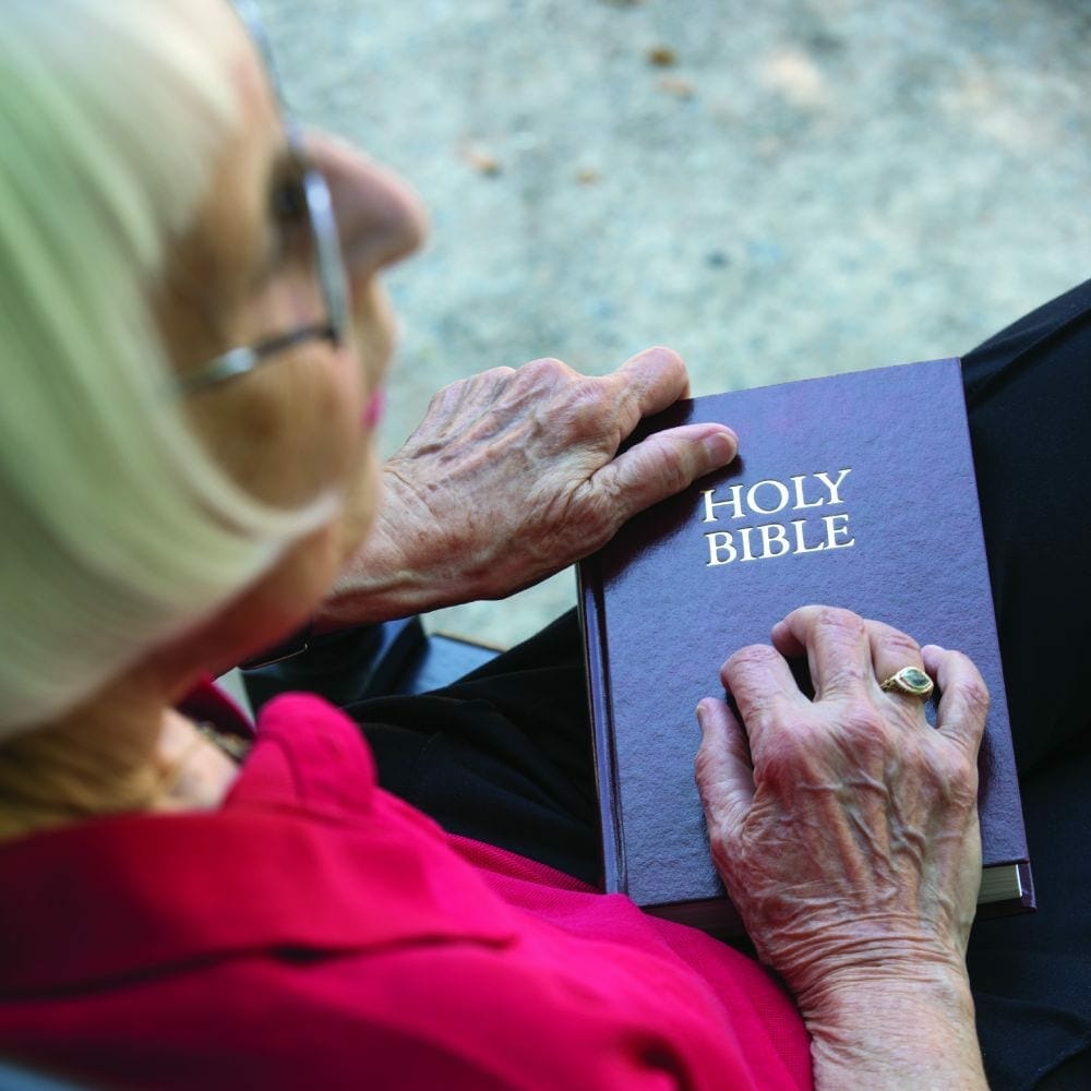 senior woman holding a bible